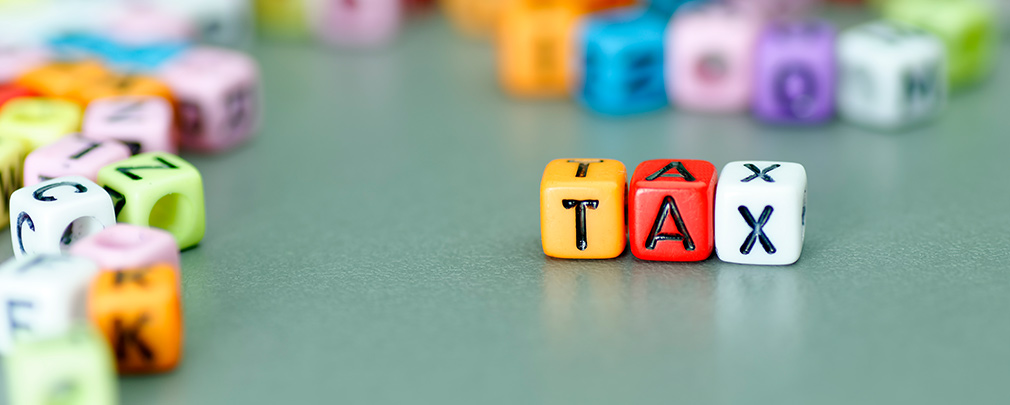 4_how-to-check-if-youre-on-the-right-tax-code Dice written with "Tax"
