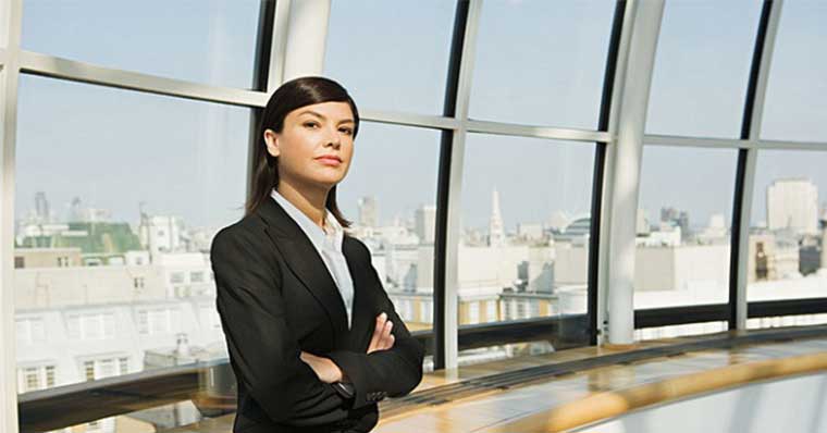 Business woman standing against the windows