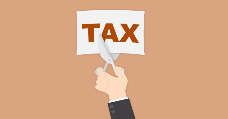 person cutting a tax paper with scissors