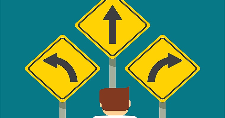Man standing at direction signs