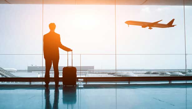 Man standing against sunset at an airport Man standing against sunset at an airport