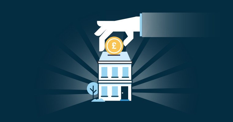 Hand depositing coin into house-shaped piggy bank