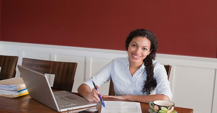 Smiling woman sitting at a desk