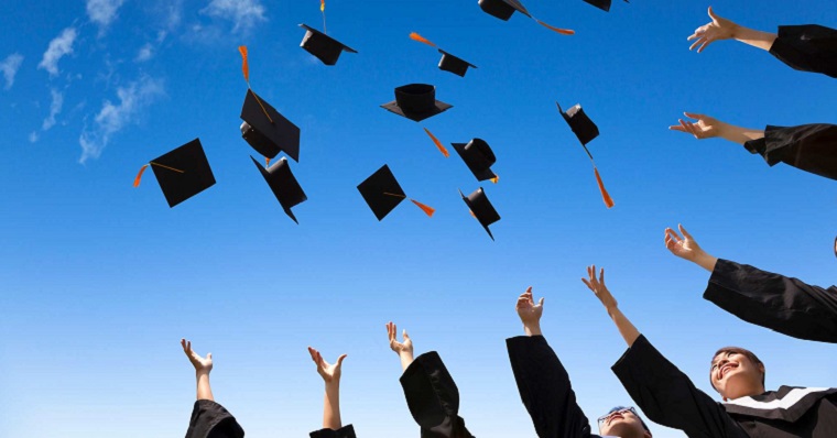 Graduation caps thrown in the air 