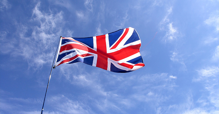 UK flag flying against clear blue sky