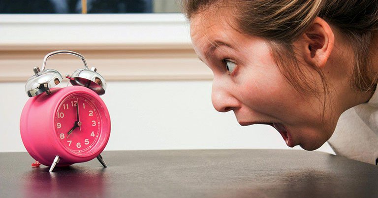 Woman screaming at an alarm clock