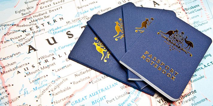 Australian passports on top of a map of Australia Australian passports on top of a map of Australia