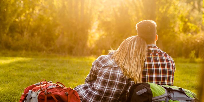 Couple sitting on the grass together Couple sitting on the grass together